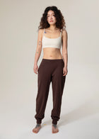 Front view of model standing in brown Flowmango jogger pants