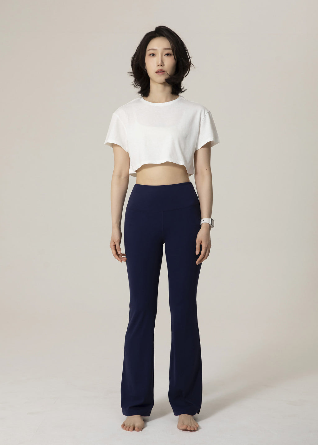 Front view of model wearing navy Deep Flow Flared Leggings