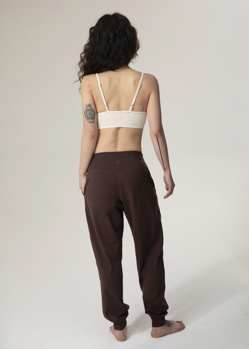 Back view of model standing in brown Flowmango jogger pants