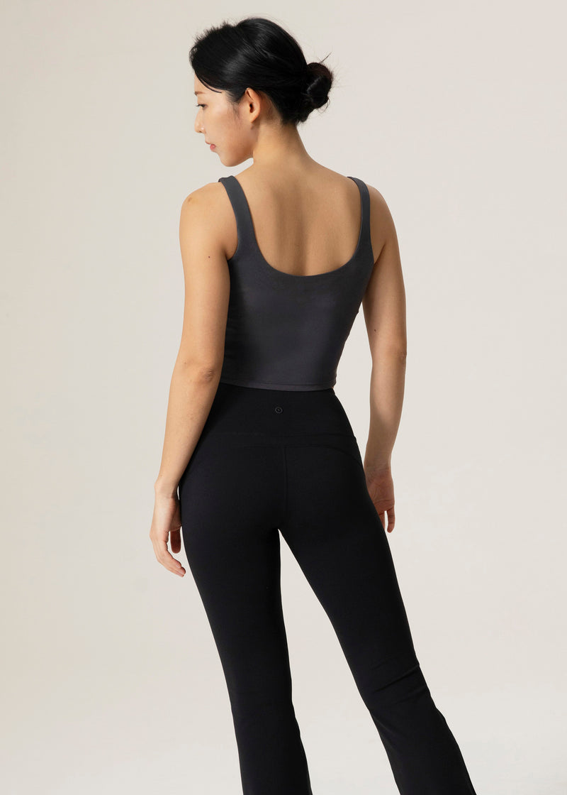 Back view of the charcoal Urban Flow Tank Top on a model wearing black leggings